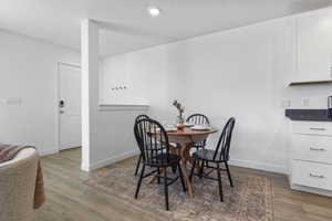 Dining area with light wood-style floors and baseboards