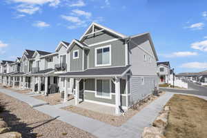 View of front of home featuring roof with shingles, board and batten siding, and a residential view