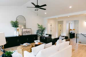 Living room with ceiling fan, light wood-type flooring, vaulted ceiling, and recessed lighting