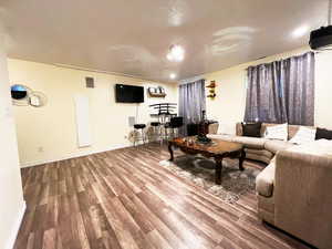 Living room with baseboards and wood finished floors