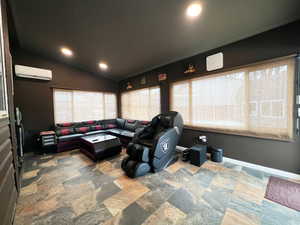 Home theater with recessed lighting, baseboards, vaulted ceiling, and a wall mounted AC