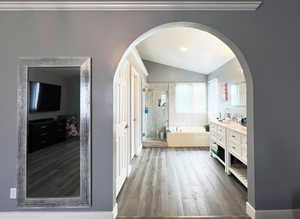 Full bath featuring a stall shower, wood finished floors, a garden tub, a textured ceiling, and vanity