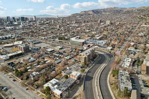 Birds eye view of property featuring a view of city and a mountain view