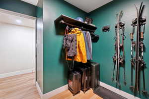 Mudroom featuring baseboards and wood finished floors