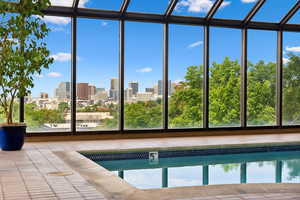 View of pool with a water view and a view of city