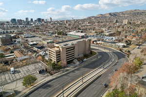 Drone / aerial view featuring a mountain view and a city view