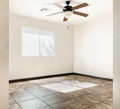 Unfurnished room featuring a ceiling fan, visible vents, baseboards, and light tile patterned flooring