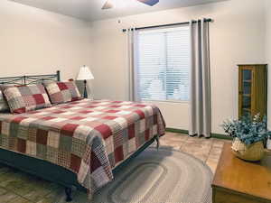 Bedroom featuring light tile patterned floors and a ceiling fan