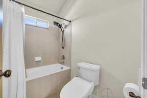 Main Full bathroom featuring toilet and shower / bath combo with shower curtain