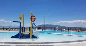 Community pool featuring fence and a mountain view