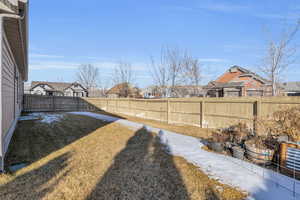 View of yard featuring a fenced backyard and garden boxes