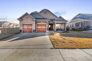 View of front of home featuring concrete driveway, roof with shingles, an attached garage, fence, and a porch