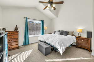 Bedroom featuring ceiling fan, light colored carpet, visible vents, baseboards, and vaulted ceiling