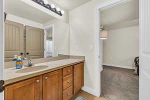 Bathroom featuring vanity, baseboards, and tile patterned floors