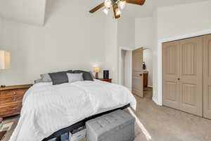 Main Bedroom featuring baseboards, light colored carpet, ceiling fan, high vaulted ceiling, and a closet