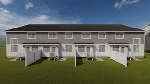 Back of property featuring roof with shingles, board and batten siding, and a yard