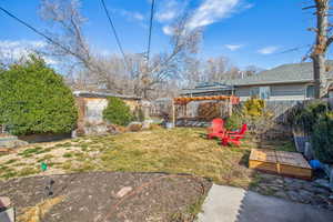 View of yard with a garden, fence, and a gazebo