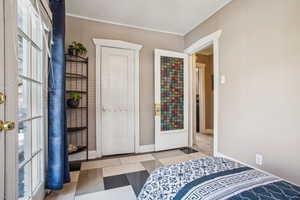 Bedroom featuring ornamental molding and baseboards