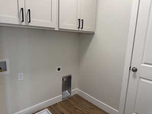 Washroom featuring cabinet space, baseboards, dark wood-style flooring, hookup for an electric dryer, and washer hookup