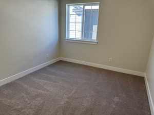 Unfurnished room with carpet and baseboards