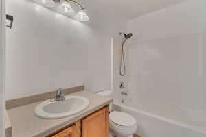 Full bathroom featuring toilet, shower / tub combination, and vanity