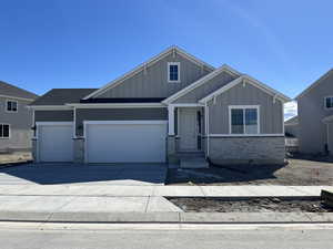 Craftsman house with an attached garage, driveway, stone siding, roof with shingles, and board and batten siding