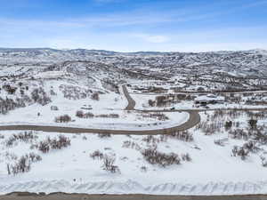 Snowy aerial view featuring a mountain view