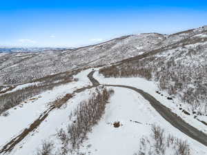 Snowy aerial view featuring a mountain view