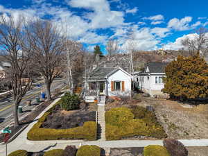 View of front of property featuring a shingled roof and covered porch