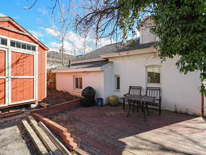 Deck featuring an outdoor structure and a storage shed