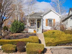 Bungalow-style house with a porch and stucco siding