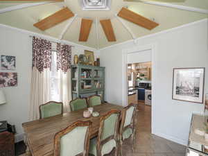 Dining area featuring washer / dryer and lofted ceiling