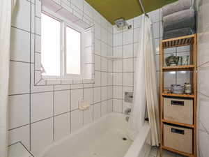 Full bathroom with shower / bath combo with shower curtain