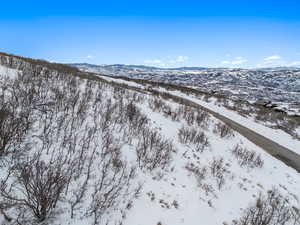 Snowy aerial view featuring a mountain view