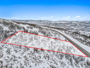 Snowy aerial view featuring a mountain view
