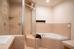 Bathroom featuring separate shower and tub and tile patterned floors