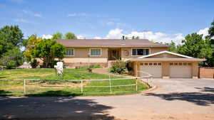 View of front facade with a front yard and a garage