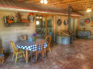 Dining space with a wood stove and concrete floors