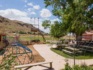 View of play area with a rural view and a mountain view