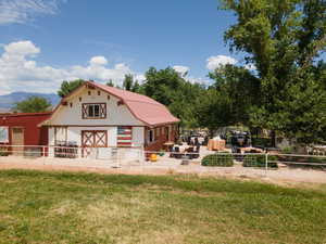 Exterior space with a mountain view, an outdoor structure, and a lawn