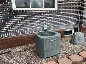 Details featuring central AC and brick siding