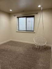 Carpeted spare room featuring recessed lighting, visible vents, and baseboards