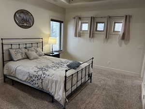 Carpeted bedroom featuring baseboards