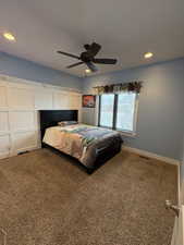 Bedroom featuring carpet, visible vents, baseboards, and recessed lighting