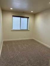 Empty room featuring baseboards, carpet flooring, and recessed lighting