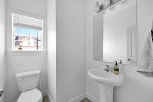 Bathroom featuring toilet and baseboards