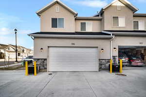 Exterior space with stone siding, central AC unit, and stucco siding