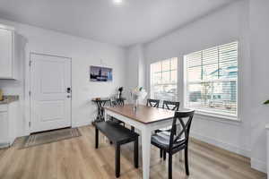 Dining room with baseboards and light wood finished floors