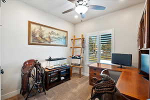 Office space with carpet floors, baseboards, and a ceiling fan