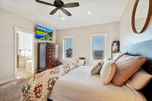 Bedroom featuring a ceiling fan, recessed lighting, light carpet, and ensuite bath